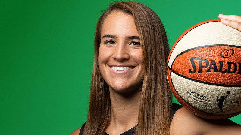 Sabrina Ionescu holds a basketball
